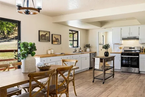 a kitchen with a stove a refrigerator and cabinets