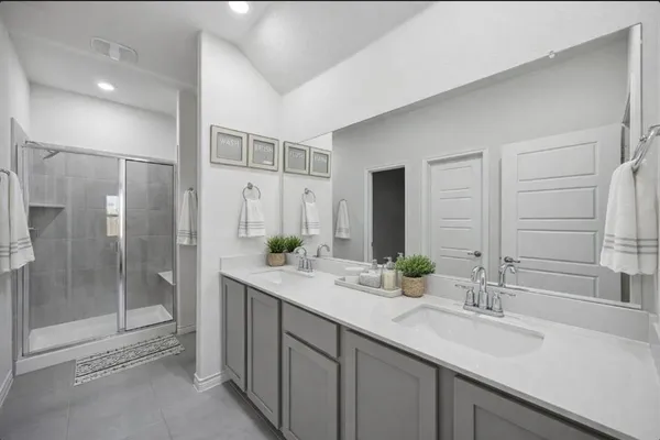 a bathroom with a shower sink and mirror