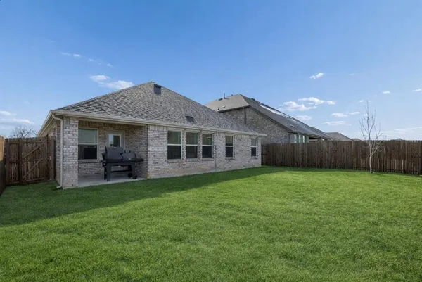 a view of a house with a backyard and porch