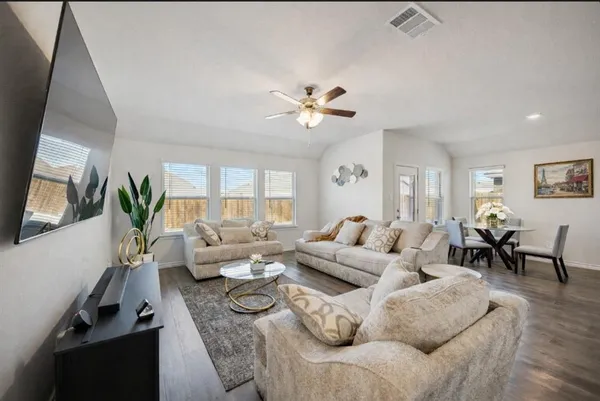a living room with furniture potted plant and a window