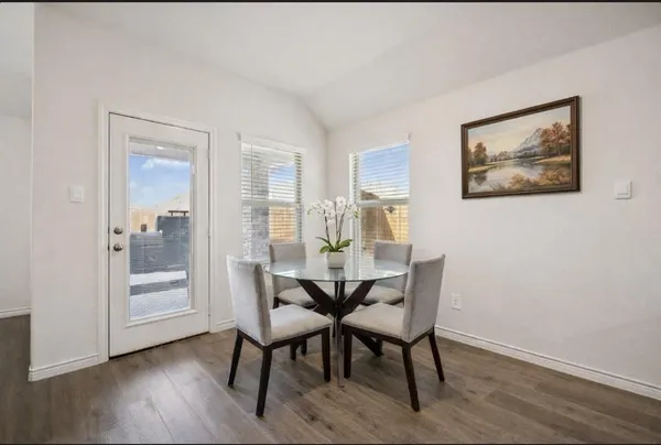 a view of a dining room with furniture and wooden floor