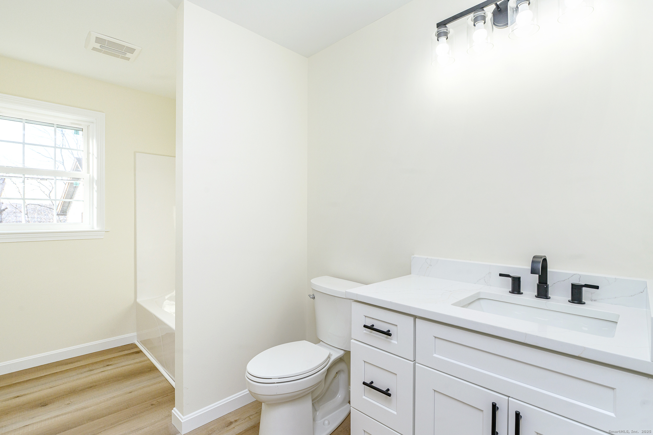 6 Prospect Street Putnam, CT 06260 - Photo 20 of 40 a bathroom with a sink a toilet and a window