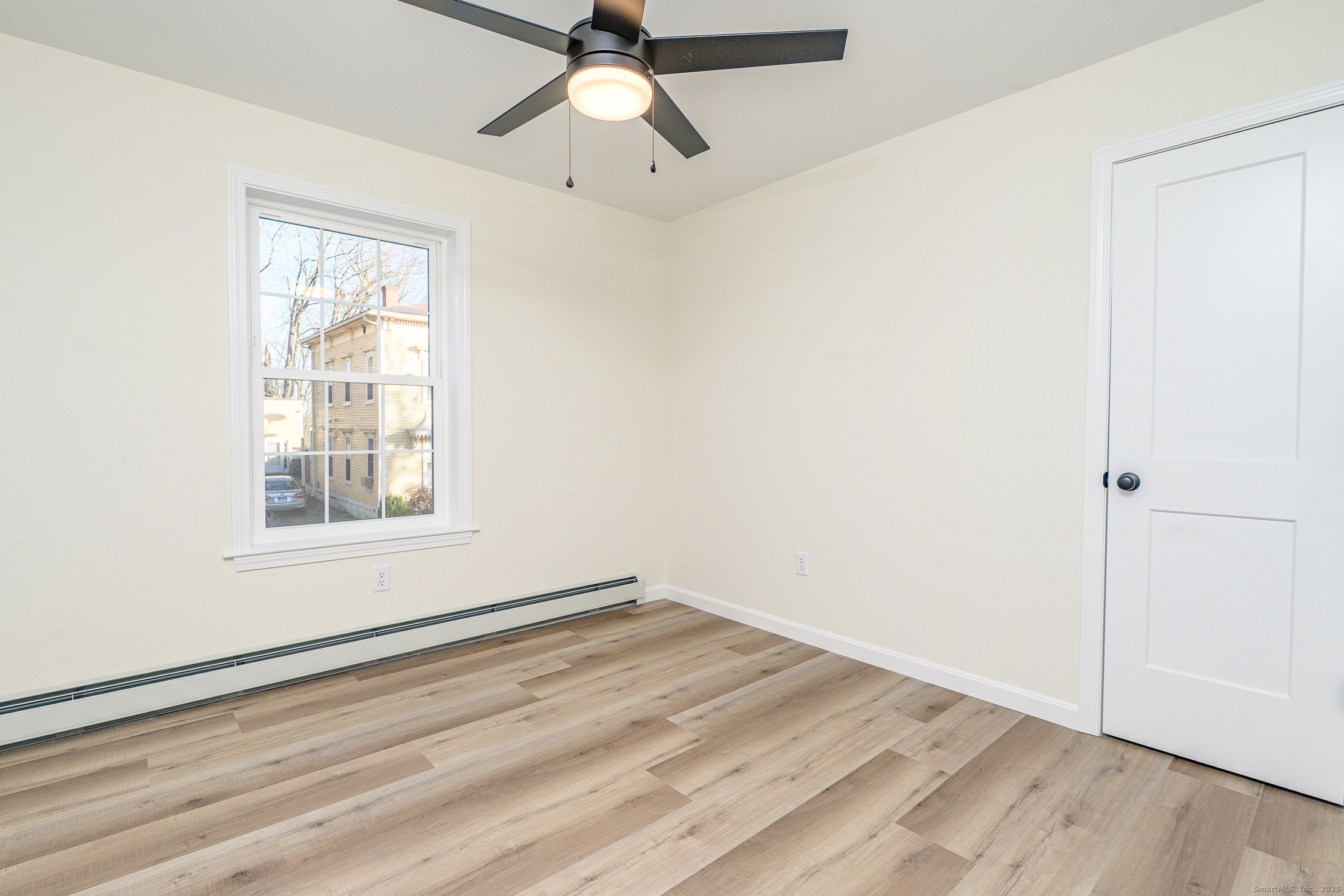 6 Prospect Street Putnam, CT 06260 - Photo 24 of 40 an empty room with a window and a fan