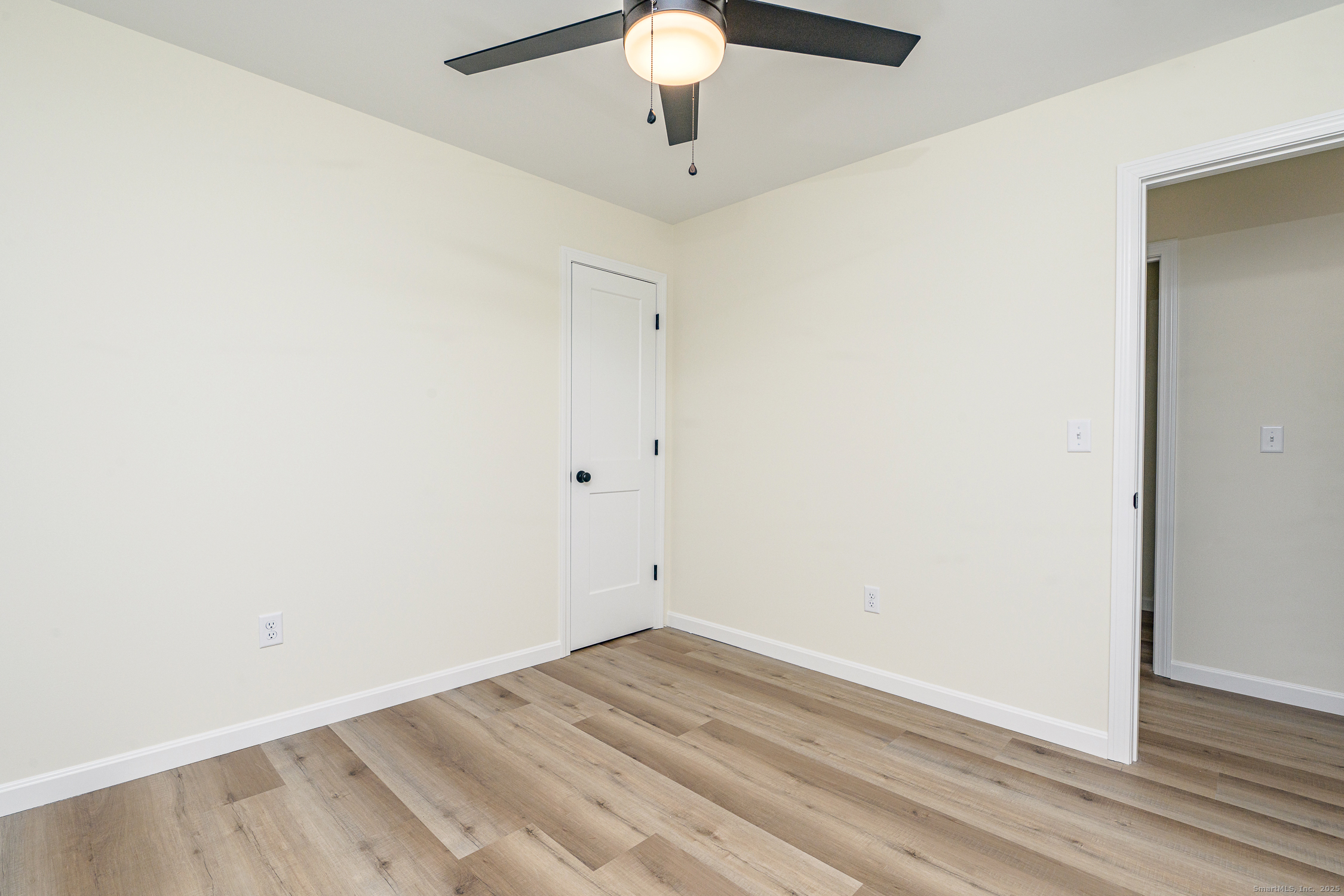 6 Prospect Street Putnam, CT 06260 - Photo 25 of 40 an empty room with wooden floor and chandelier fan