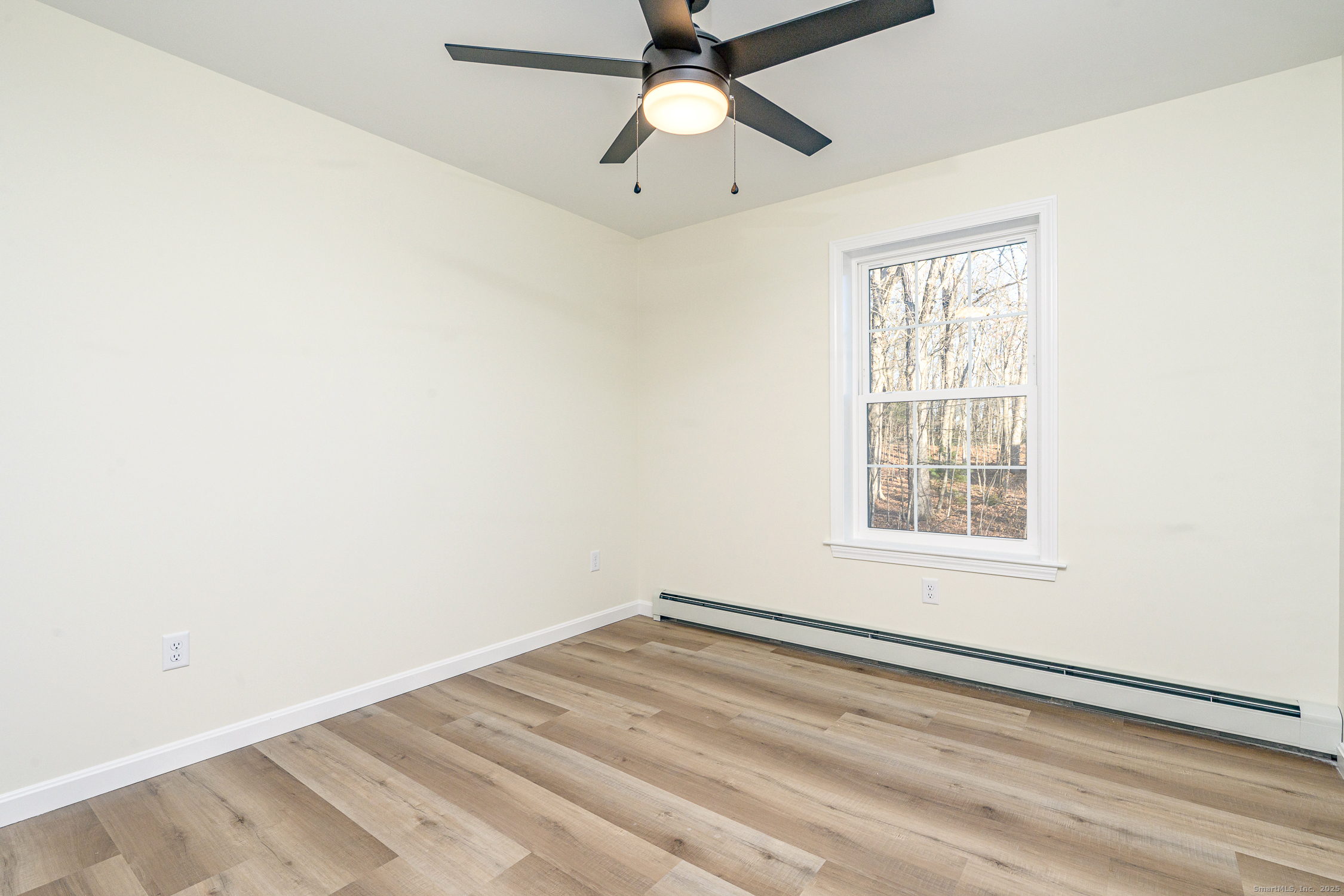 6 Prospect Street Putnam, CT 06260 - Photo 26 of 40 an empty room with a window and a fan