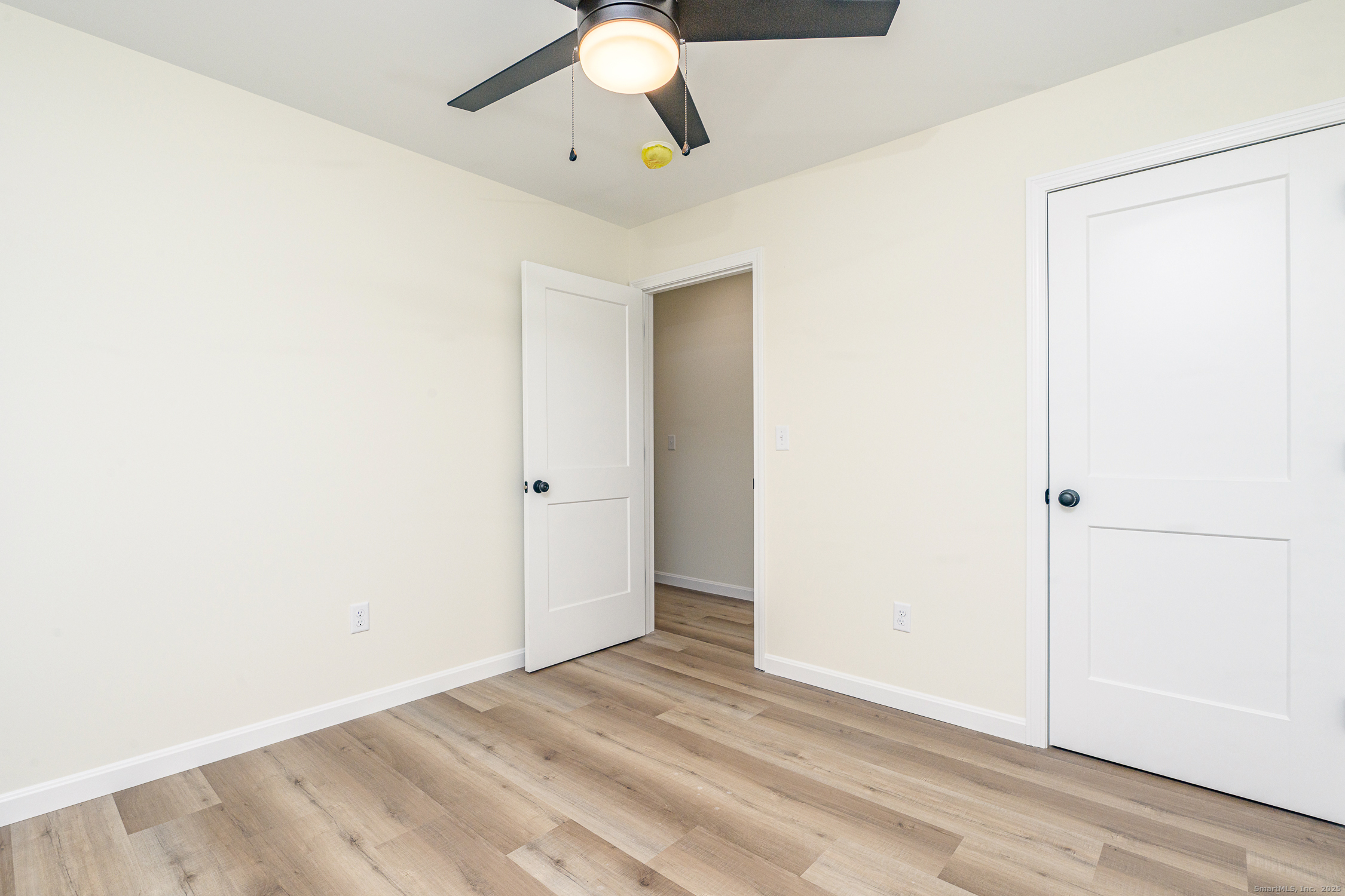 6 Prospect Street Putnam, CT 06260 - Photo 27 of 40 an empty room with a ceiling fan and carpet