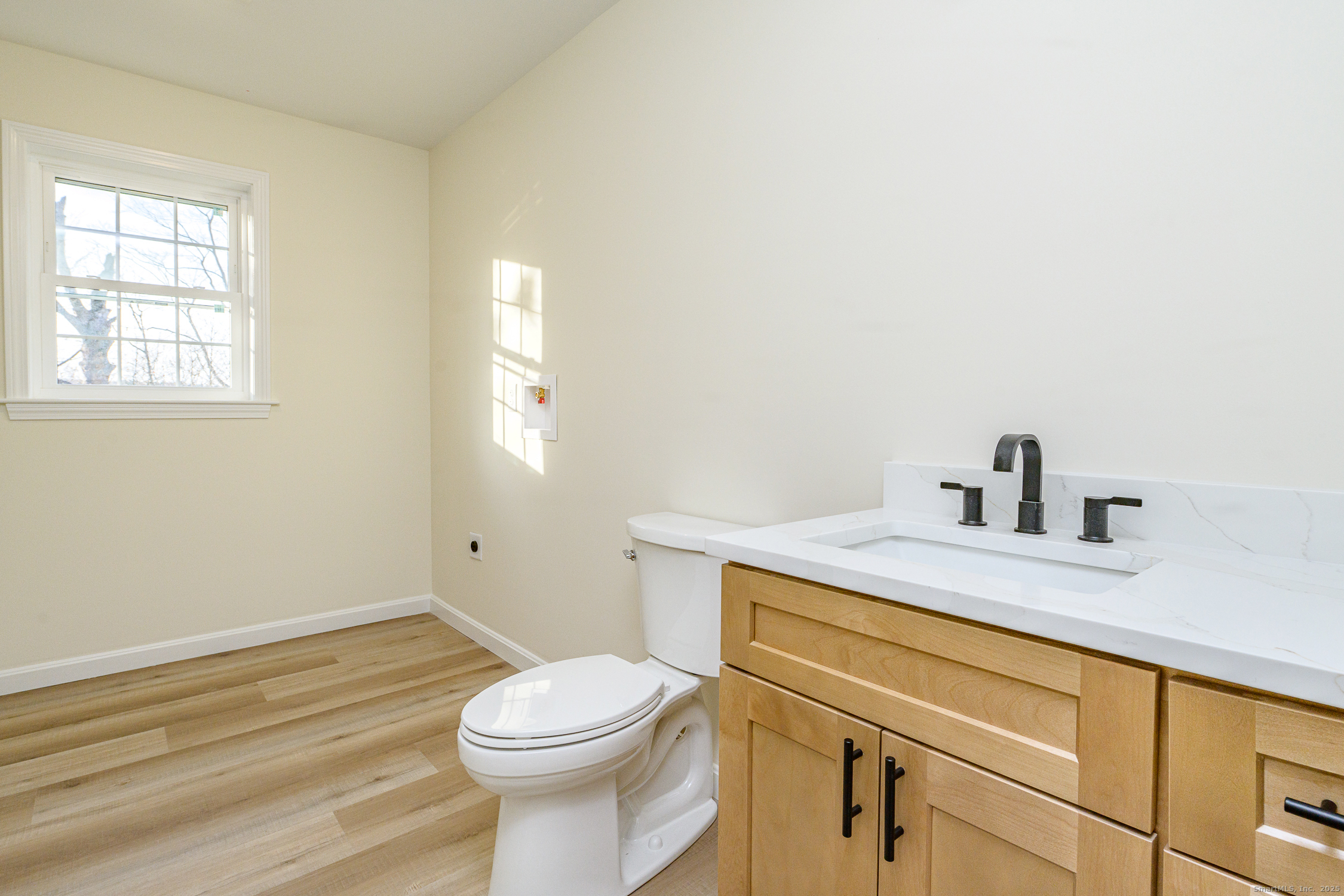 6 Prospect Street Putnam, CT 06260 - Photo 30 of 40 a bathroom with a granite countertop toilet sink and mirror