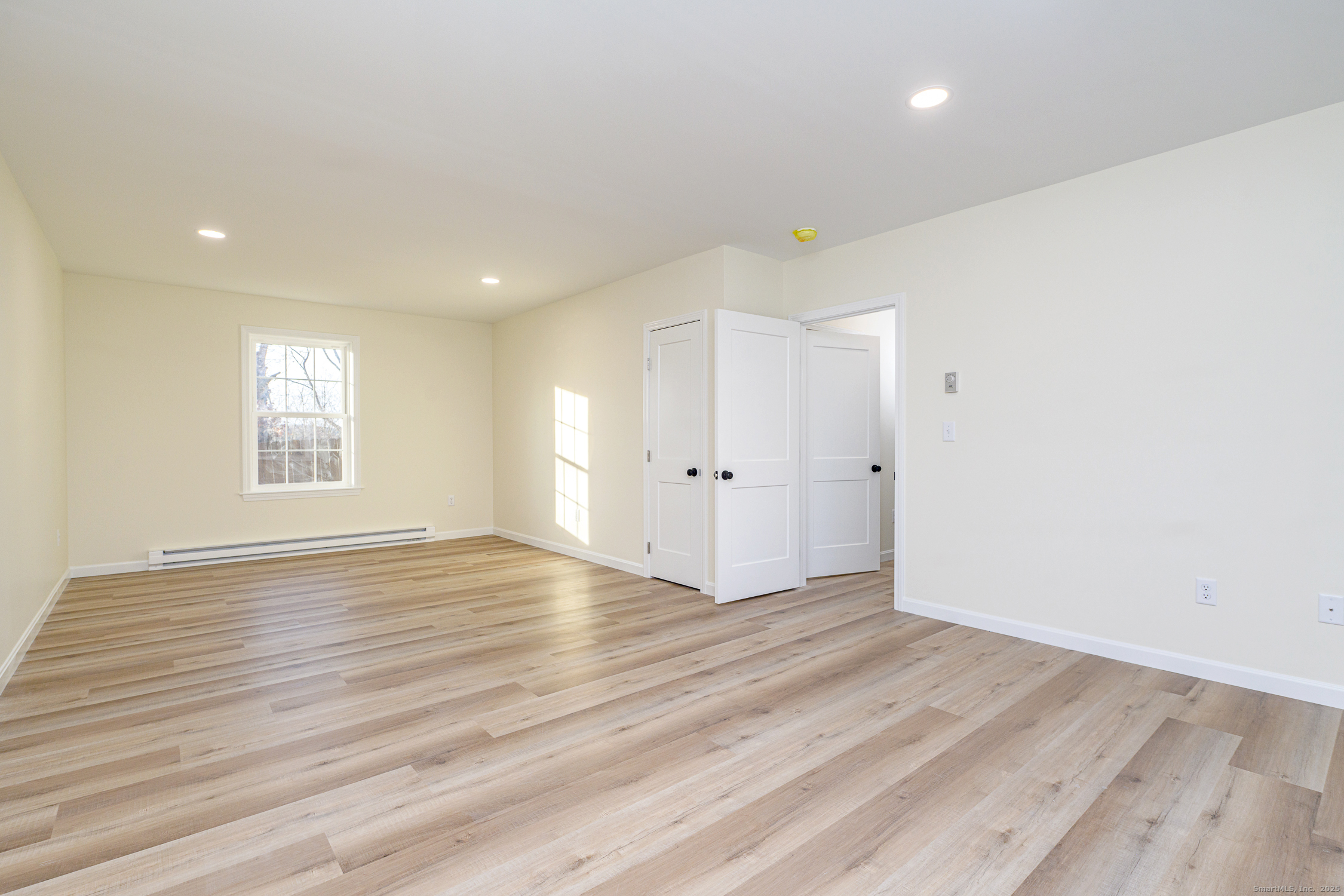 6 Prospect Street Putnam, CT 06260 - Photo 32 of 40 an empty room with wooden floor and windows