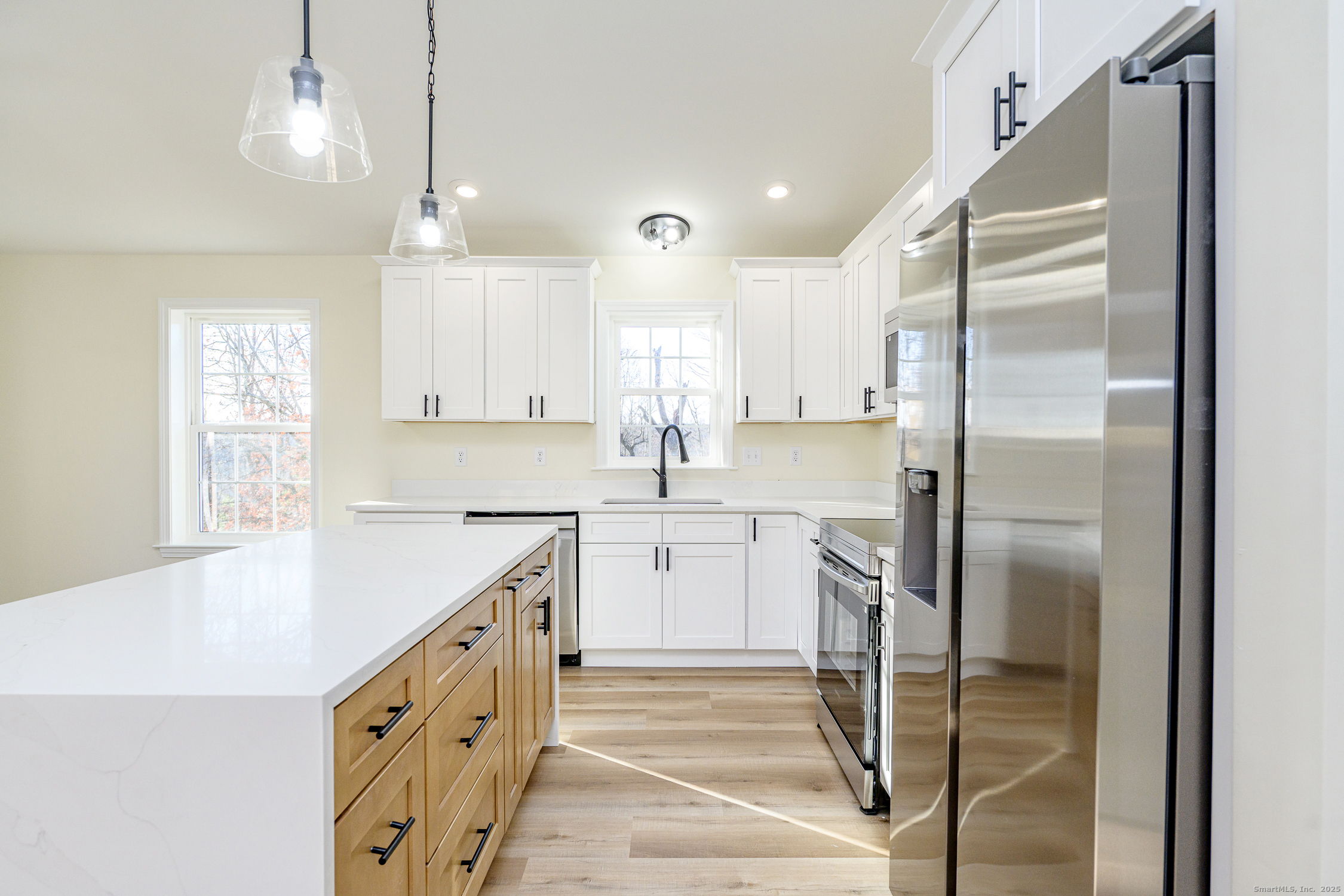6 Prospect Street Putnam, CT 06260 - Photo 7 of 40 a kitchen with white cabinets and refrigerator