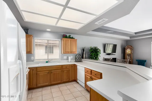 a kitchen with a sink appliances and cabinets
