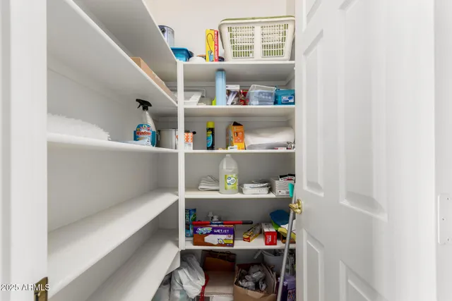 a room with a baby crib and a wooden floor