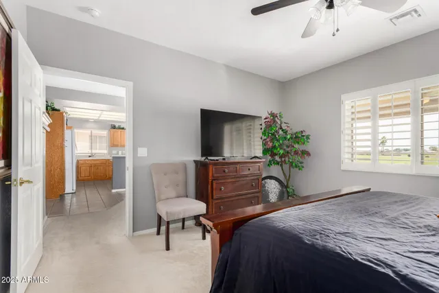 a bedroom with a bed and a potted plant