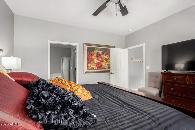 a bedroom with bed and a flat screen tv