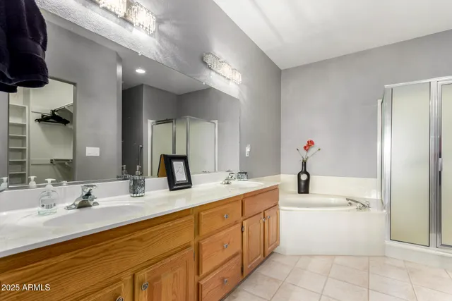 a bathroom with a granite countertop sink mirror and bathtub