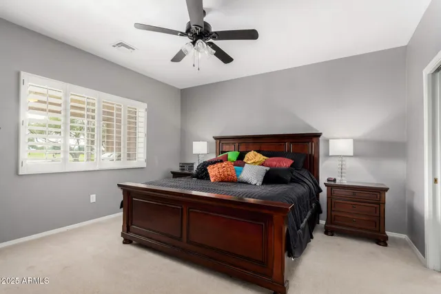 a bedroom with a bed and a baby bed