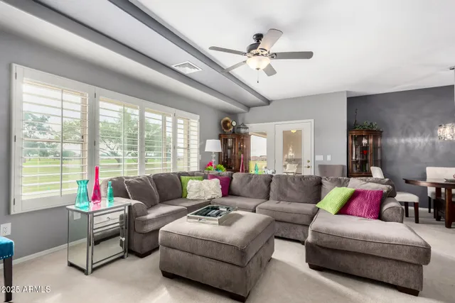 a living room with furniture and a large window