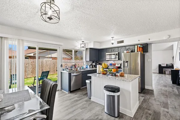 a kitchen with stainless steel appliances granite countertop a stove and a sink