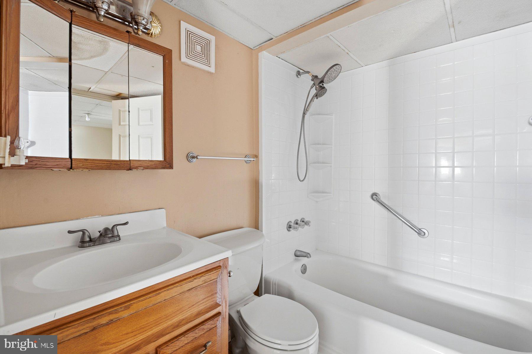 7526 Lemon Tree Court Hanover, MD 21076 - Photo 23 of 27 a bathroom with a sink toilet and shower
