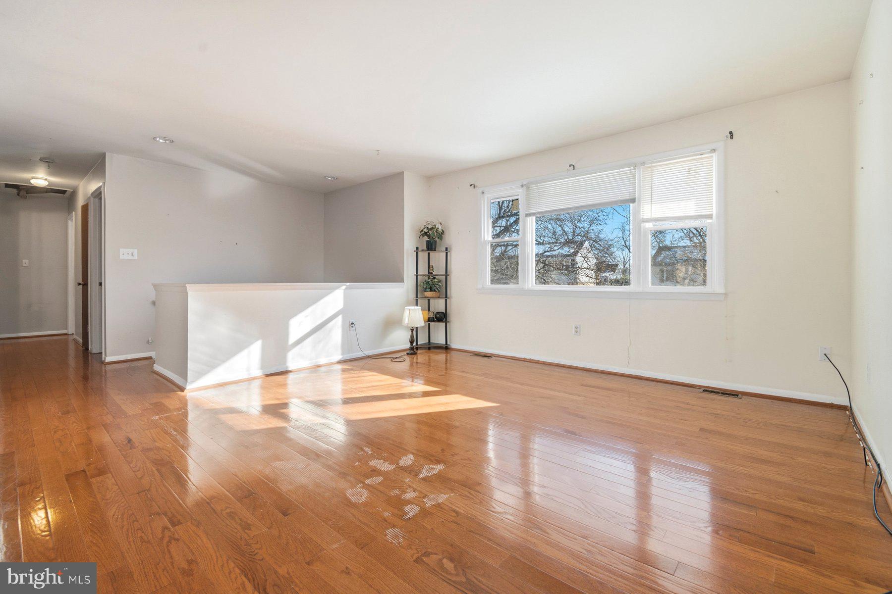 7526 Lemon Tree Court Hanover, MD 21076 - Photo 3 of 27 a view of an empty room with wooden floor and a window