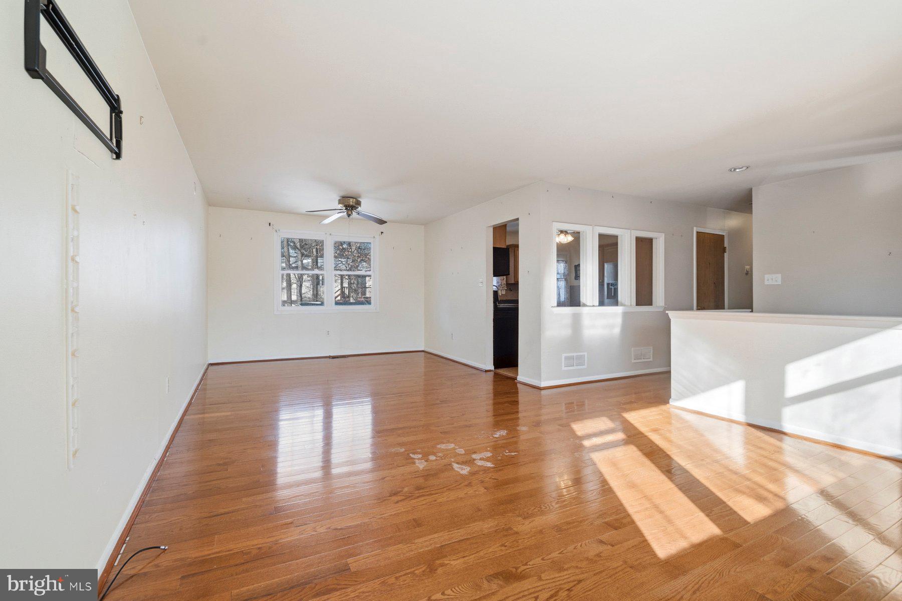 7526 Lemon Tree Court Hanover, MD 21076 - Photo 4 of 27 a view of a living room with hardwood floor and a ceiling fan