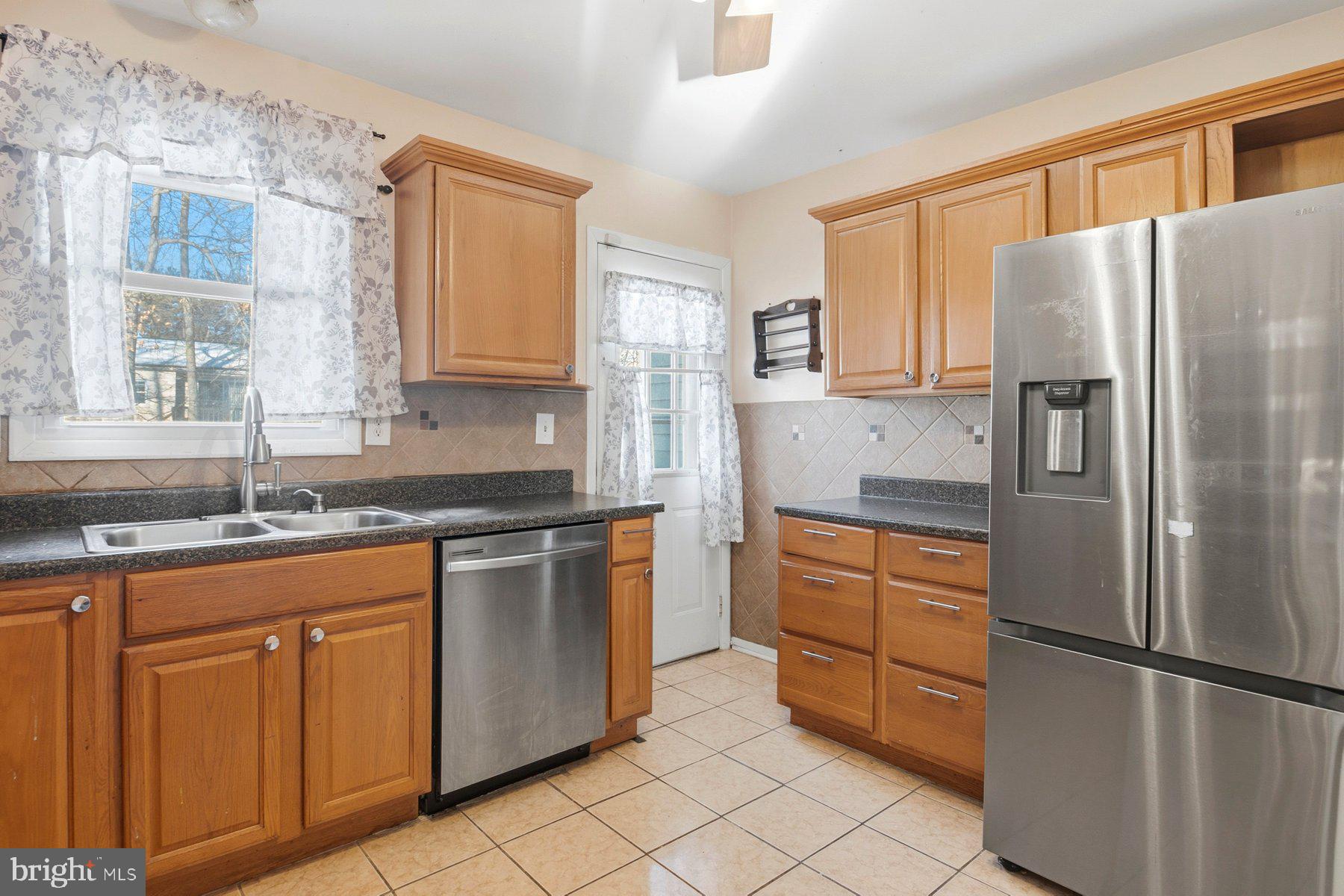 7526 Lemon Tree Court Hanover, MD 21076 - Photo 7 of 27 a kitchen with stainless steel appliances granite countertop a refrigerator sink and stove