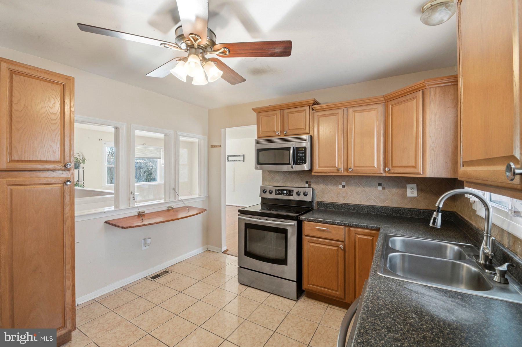 7526 Lemon Tree Court Hanover, MD 21076 - Photo 9 of 27 a kitchen with stainless steel appliances granite countertop a sink and cabinets