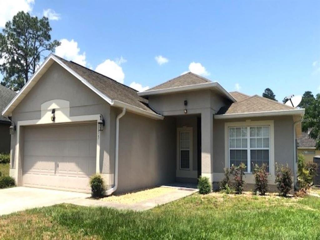 4955 Southwest 129th Place Ocala, FL 34473 - Photo 1 of 19 a front view of a house with yard and porch