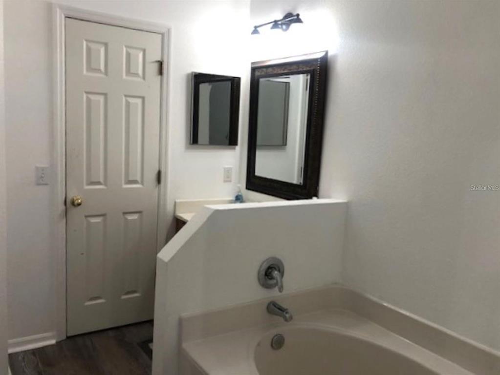 4955 Southwest 129th Place Ocala, FL 34473 - Photo 12 of 19 a bathroom with a sink and mirror