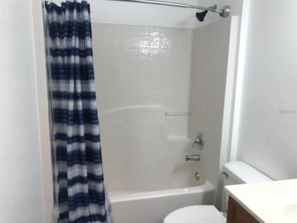 4955 Southwest 129th Place Ocala, FL 34473 - Photo 16 of 19 a bathroom with a shower a toilet and sink
