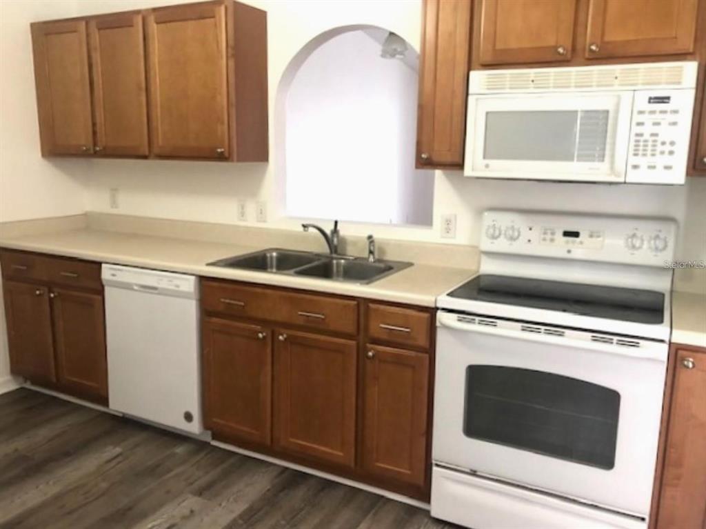 4955 Southwest 129th Place Ocala, FL 34473 - Photo 5 of 19 a kitchen with a sink stove and cabinets