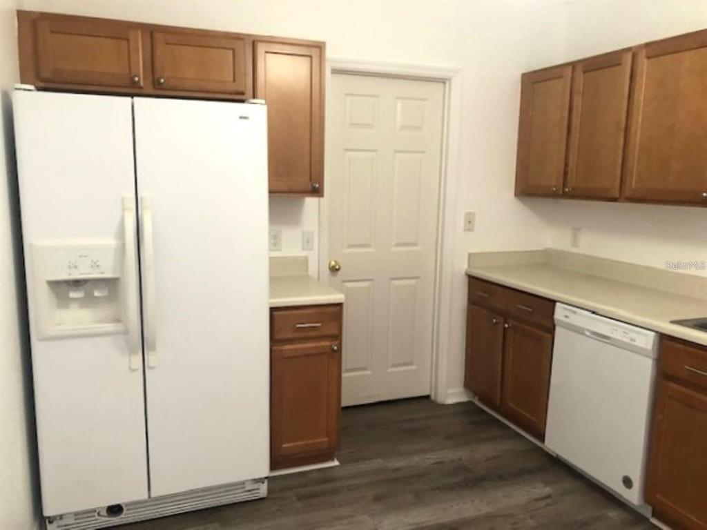 4955 Southwest 129th Place Ocala, FL 34473 - Photo 7 of 19 a kitchen with a refrigerator sink and cabinets