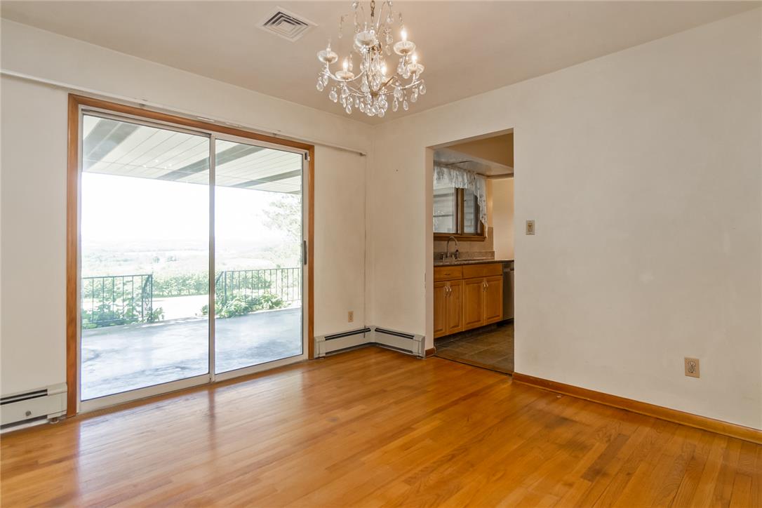 1657 Clearview Road Coplay, PA 18037 - Photo 37 of 77 A radiant chandelier illuminates the beautiful hardwood floors, offering a clear view to the scenic outdoors.