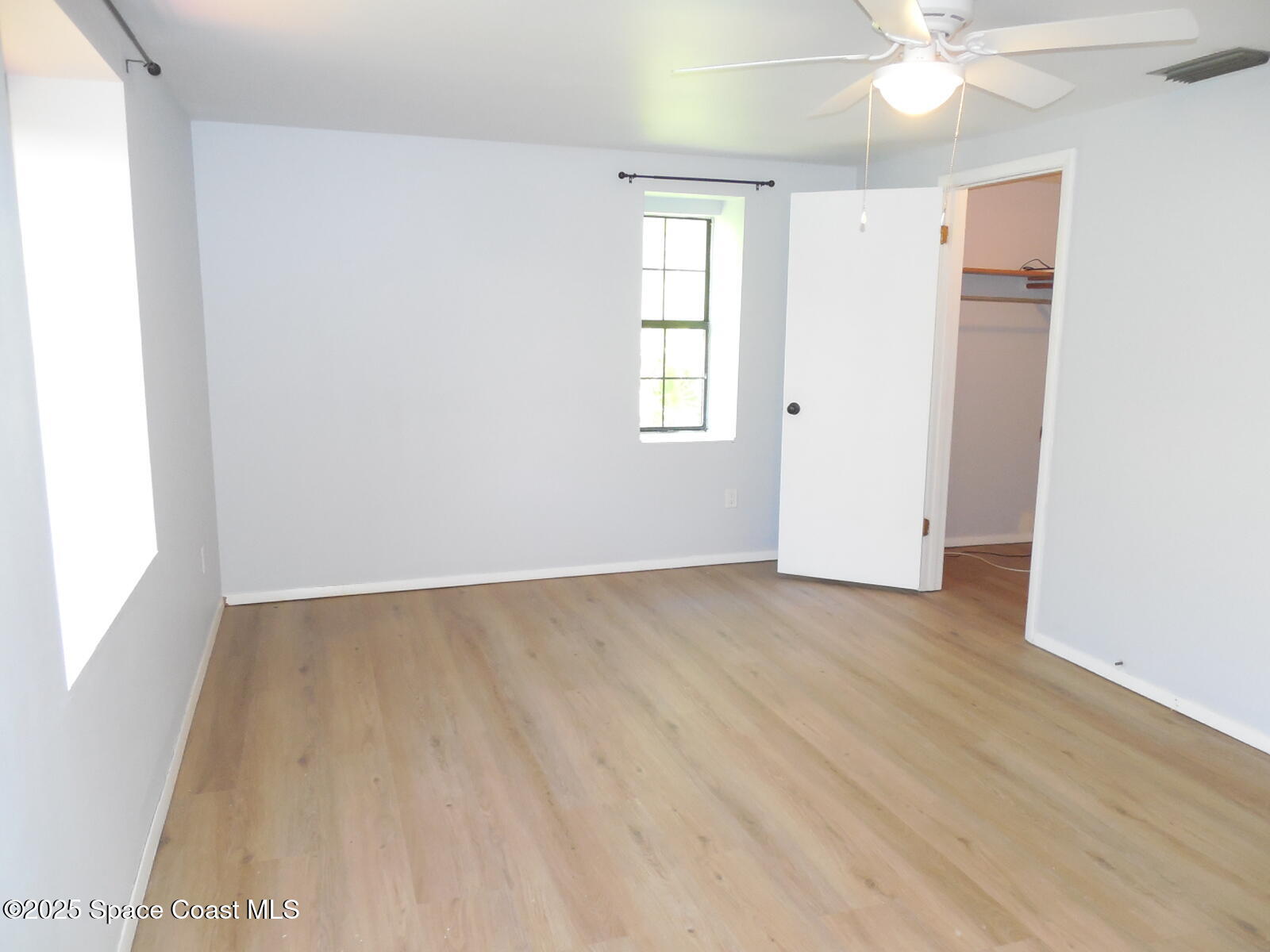 345 Ocean View Lane Indialantic, FL 32903 - Photo 12 of 31 an empty room with wooden floor and windows