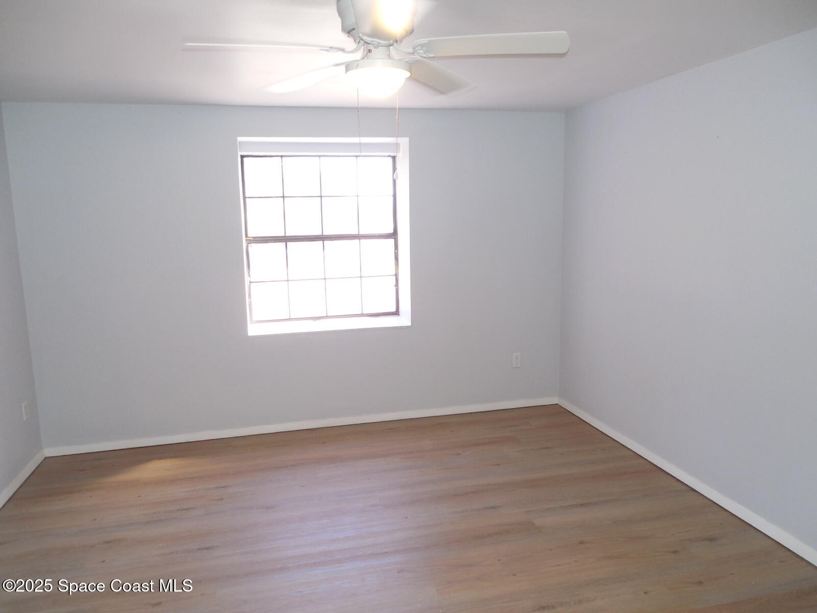345 Ocean View Lane Indialantic, FL 32903 - Photo 16 of 31 an empty room with wooden floor and windows