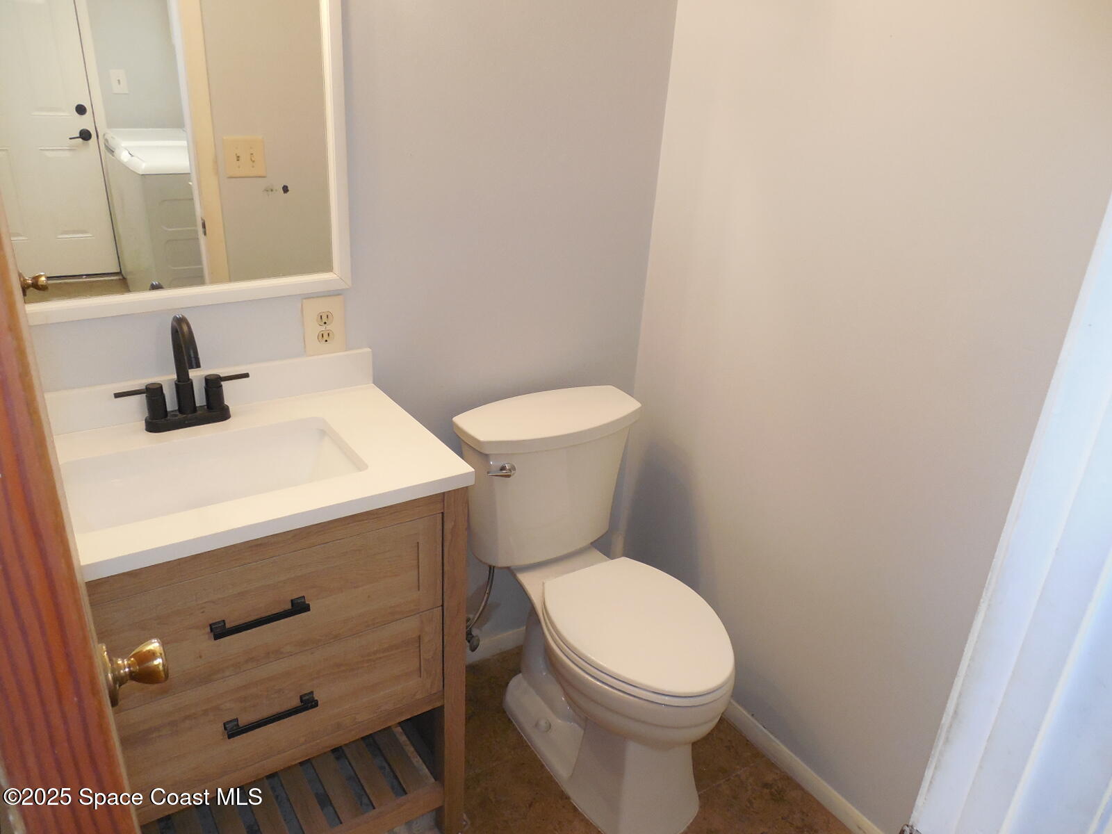 345 Ocean View Lane Indialantic, FL 32903 - Photo 9 of 31 a bathroom with a sink a toilet and a mirror