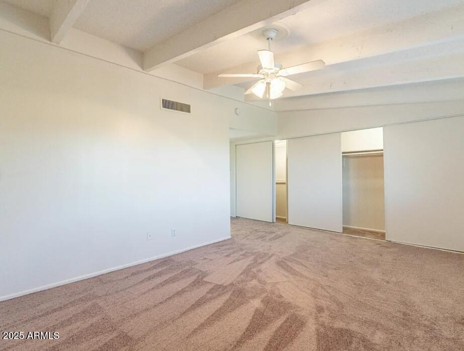 5128 North 15th Street, Unit 1 Phoenix, AZ 85014 - Photo 3 of 4 an empty room with a ceiling fan and a window