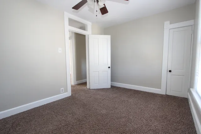 an empty room with white walls and empty shelves