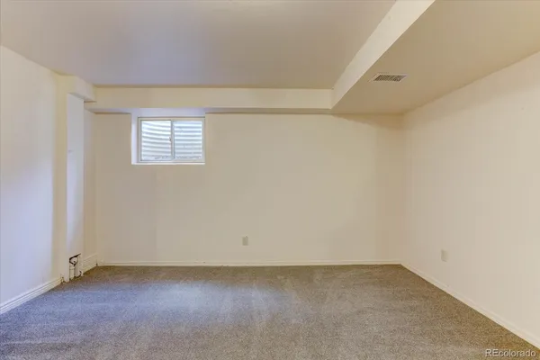 an empty room with a empty space and a window
