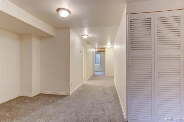 a view of hallway with a bathroom