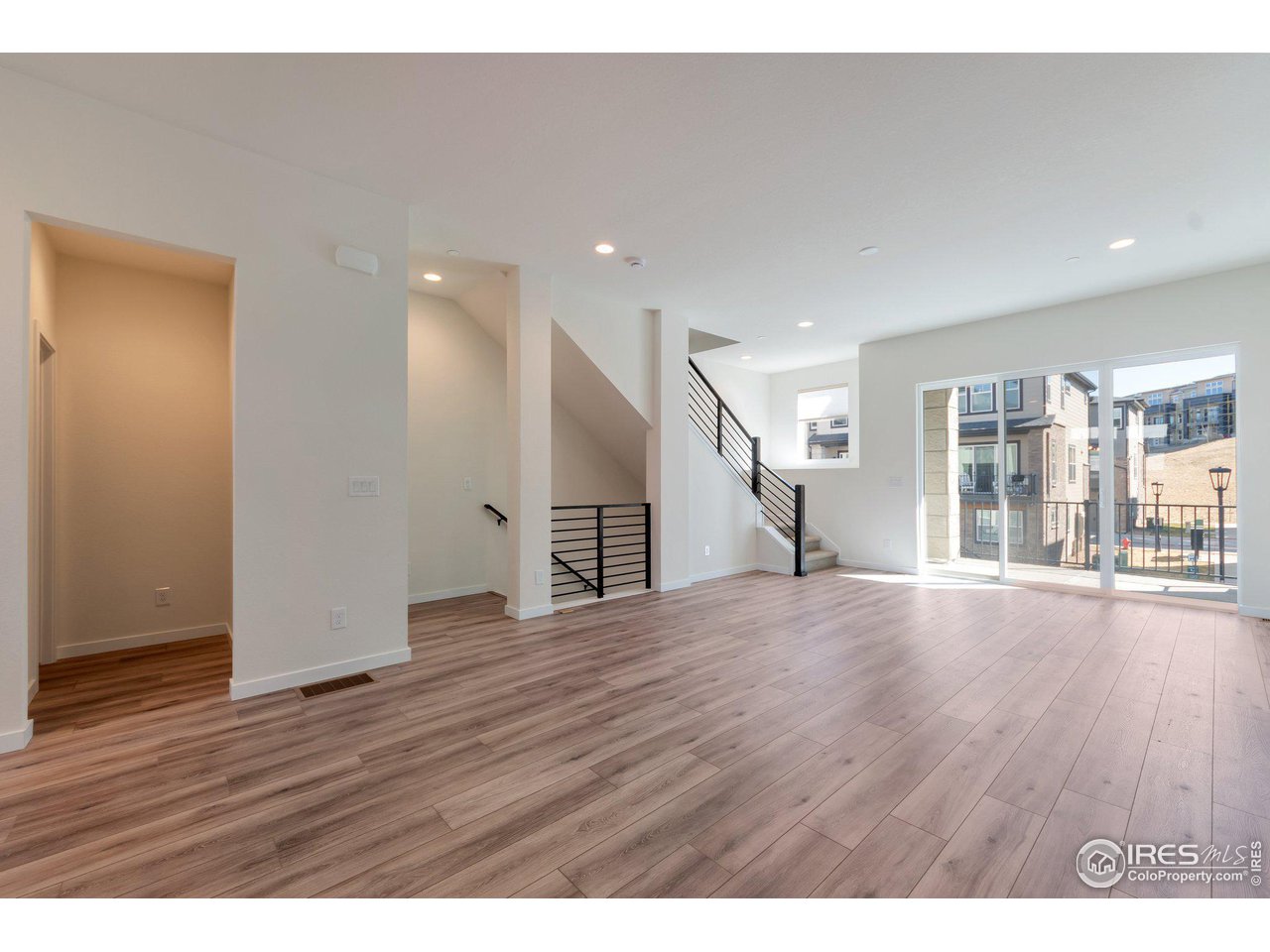 358 Promenade Drive Superior, CO 80027 - Photo 7 of 32 a view of an empty room with wooden floor and a window