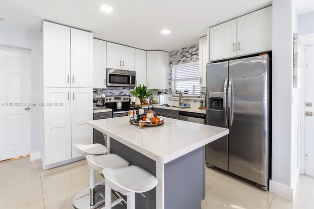 a kitchen with stainless steel appliances a refrigerator and a stove