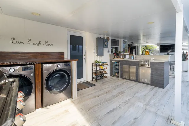 a view of a kitchen with furniture and washing machine