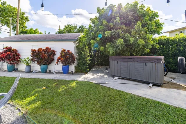 a view of a backyard with plants and a patio