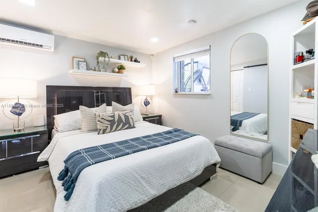 a bedroom with bed and cupboard