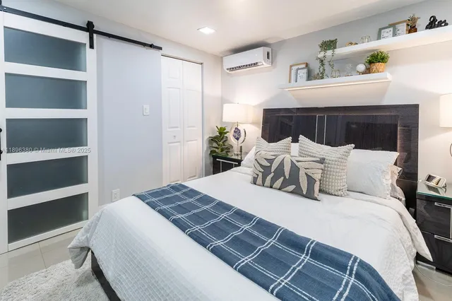 a bedroom with a bed and with closet