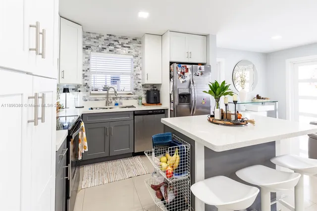 a kitchen with a stove a table and chairs in it