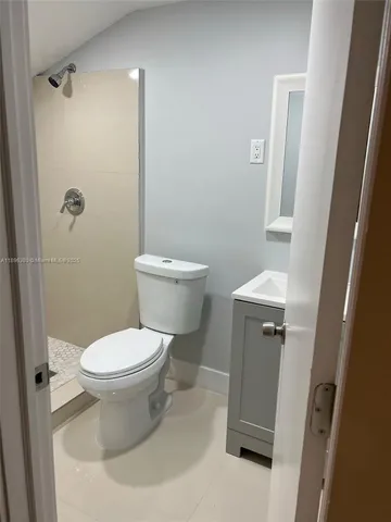a white toilet sitting next to a bathroom sink