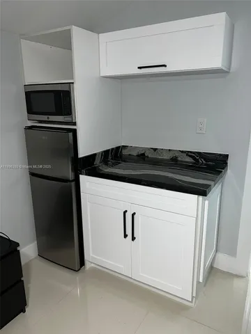 a kitchen with a refrigerator stove and microwave