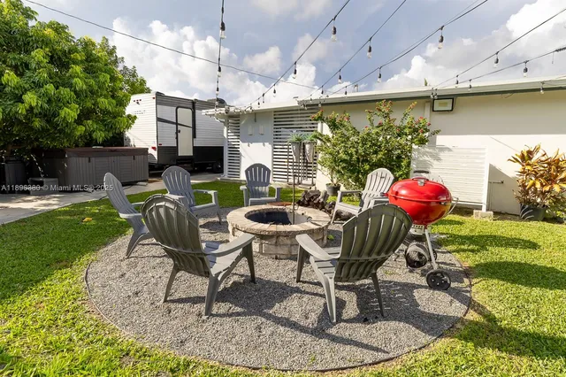 a view of an chairs and table in patio