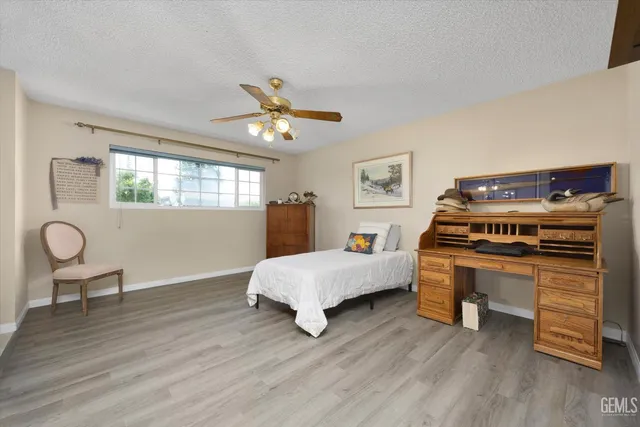 a bed room with a bed and a chair